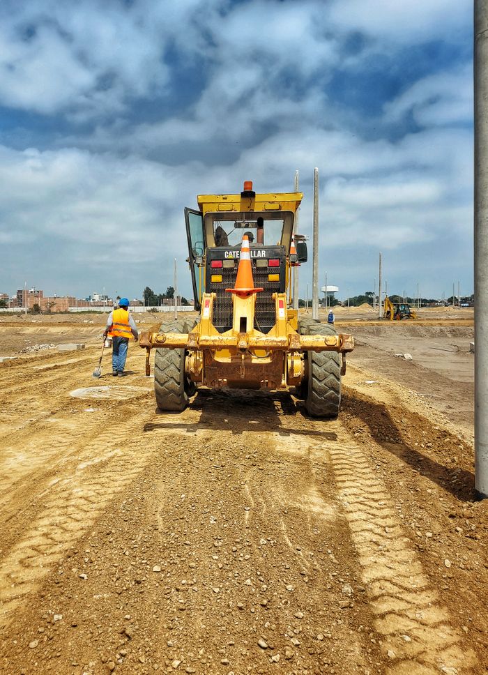 Crafting Captivating Headlines: Your awesome post title goes here Motor grader on a construction site preparing dirt ground on a sunny day.